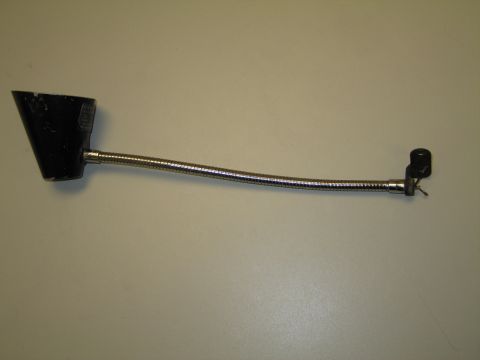 1991 Ford LTD Crown Victoria - Black-shaded gooseneck lamp with chrome flexible neck propped vertically on a tan surface.
