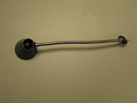 1991 Ford LTD Crown Victoria - Gooseneck lamp resting on its round black shade with chrome flexible neck rising upward against a tan background.