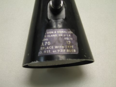 1991 Ford LTD Crown Victoria - Black conical lamp shade with a faded label listing a model L70, 12 volts, and replacement bulb instructions.