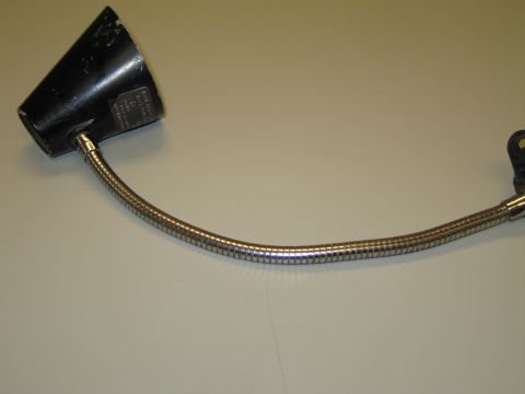1991 Ford LTD Crown Victoria - Black conical-shade gooseneck lamp with a long curved chrome flexible neck and labeled shade on a tan surface.
