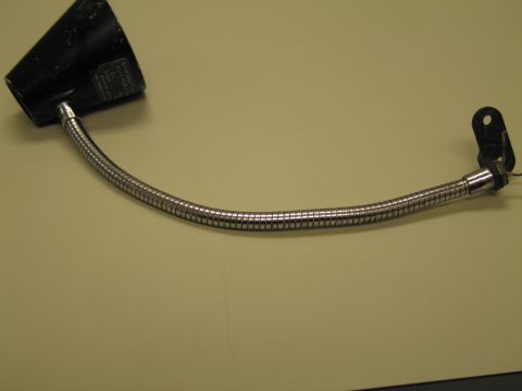 1991 Ford LTD Crown Victoria - Black-shaded gooseneck lamp with a curved chrome flexible neck and two-hole bracket mount resting on a tan surface.