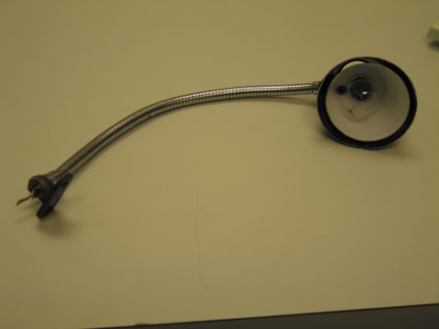 1991 Ford LTD Crown Victoria - flexible chrome gooseneck work or map lamp with a round reflector head and a small mounting base, photographed on a table.