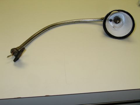 1991 Ford LTD Crown Victoria - chrome gooseneck lamp with a round reflector and angled mounting bracket, shown full-length on a tabletop.