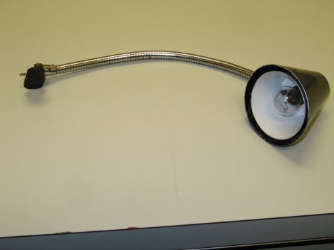 1991 Ford LTD Crown Victoria - flexible chrome gooseneck lamp with a black conical reflector shade and exposed bulb, resting on a light surface.