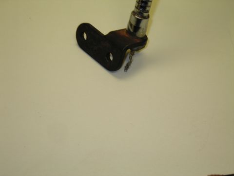 1991 Ford LTD Crown Victoria - Detail of the L-shaped two-hole metal mounting bracket and frayed wire at the base of a chrome gooseneck lamp.