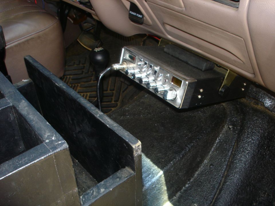 The CB is mounted under the dash.  The block is wedged in on top to keep it at that angle so it doesnt interfere when you open the ash tray.