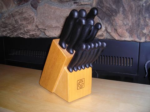 2003 Jeep TJ - A set of kitchen knives is stored in a wooden block on a counter in front of a fireplace.