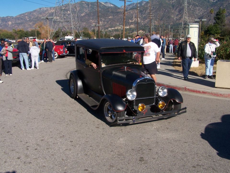 Black sedan with red accents, front view