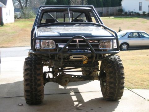 1986 Ford F-150 - This heavily modified Toyota truck features a custom bumper and off-road tires.
