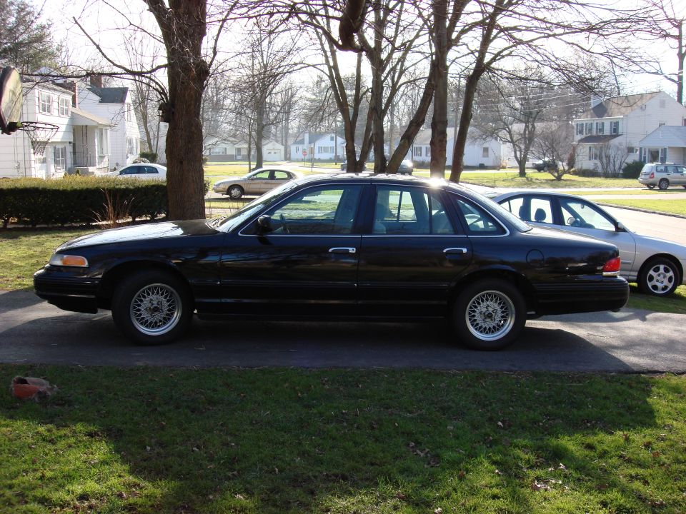 Black 2003 Ford Crown Victoria sedan, side view