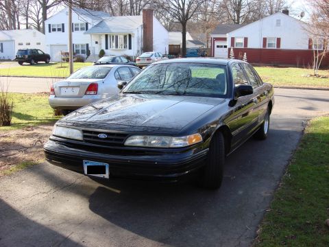 2003 Ford Crown Victoria - Black 2003 Ford Crown Victoria parked in a suburban driveway with another car behind it.