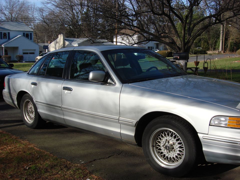 Silver 2003 Ford Crown Victoria parked in a driveway