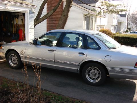 2003 Ford Crown Victoria - This silver 2003 Ford Crown Victoria is parked in front of a garage.