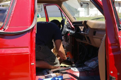 1986 Ford Bronco - Person working on the interior wiring of a 1986 Ford Bronco.