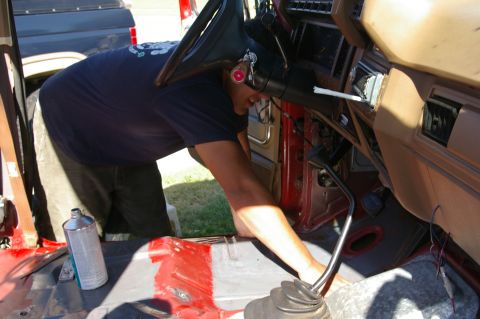 1986 Ford Bronco - Working on the interior of a 1986 Ford Bronco, focusing on the dashboard and steering column area.