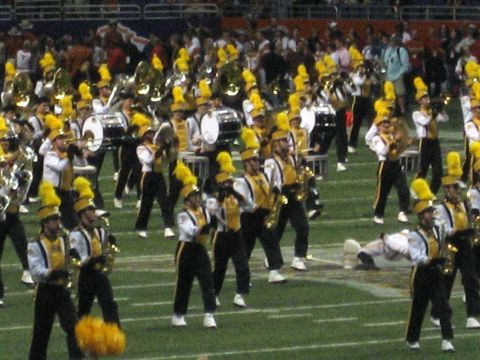 1986 Ford Bronco - A marching band performs on a football field during a game or event.