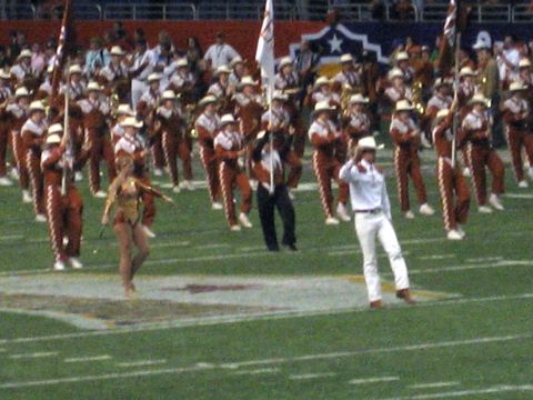 1986 Ford Bronco - A marching band and dancer perform on a football field during an event.