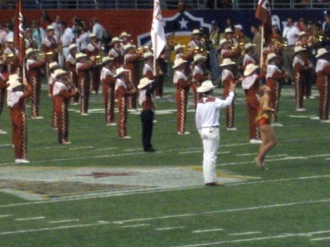 1986 Ford Bronco - A marching band performs on a football field, likely during a halftime show or event.