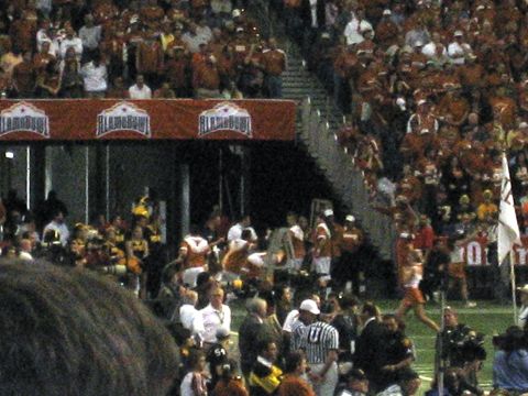 1986 Ford Bronco - Spectators fill the stands during a football game, with a prominent banner overhead.