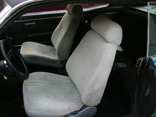 Car interior with gray cloth bucket seats and black steering wheel
