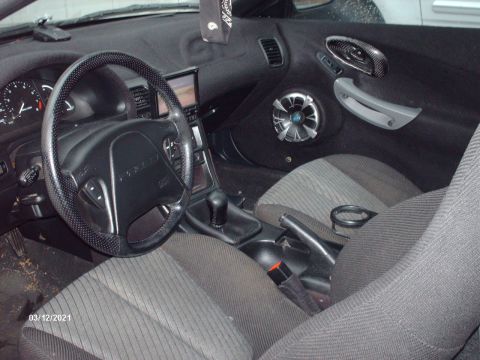 1995 Ford Probe - Interior of a 1995 Ford Probe, aftermarket speaker and carbon fiber trim on the door.
