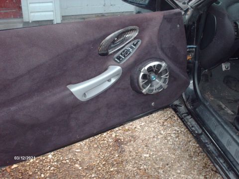 1995 Ford Probe - The interior of a car door shows custom modifications including a speaker and unique trim pieces.
