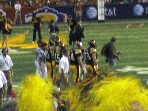 1986 Ford Bronco - A football game is underway with players and officials on the field, and fans in the stands.