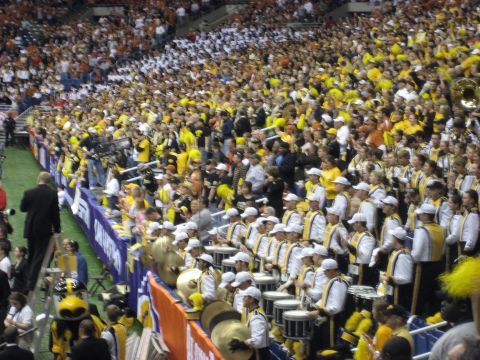 1986 Ford Bronco - A marching band performs in a crowded stadium during an event.