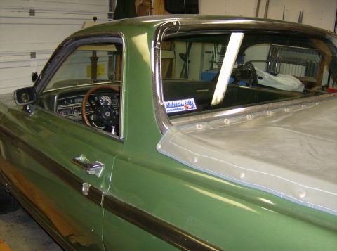 1970 Ford Ranchero - Interior view of a green pickup truck, showing the dashboard and a bed cover.