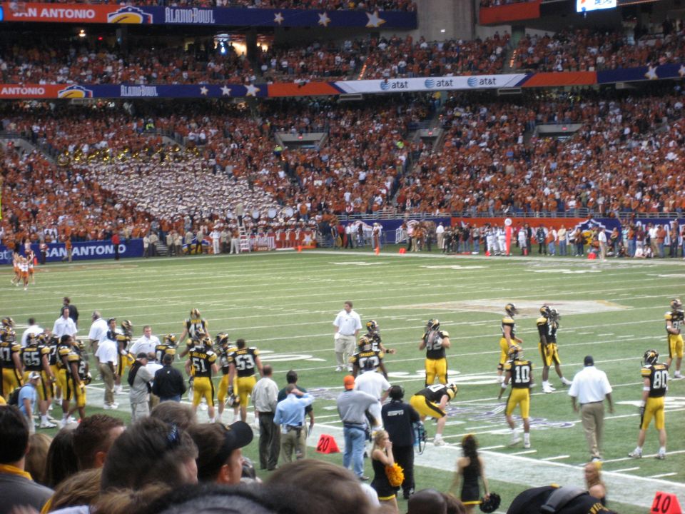 Football game in a stadium with fans and players on the field