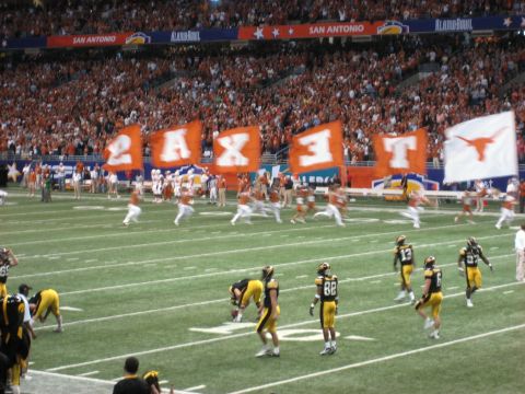 1986 Ford Bronco - Players and fans at the Alamo Bowl in San Antonio, with large orange and white flags displayed.