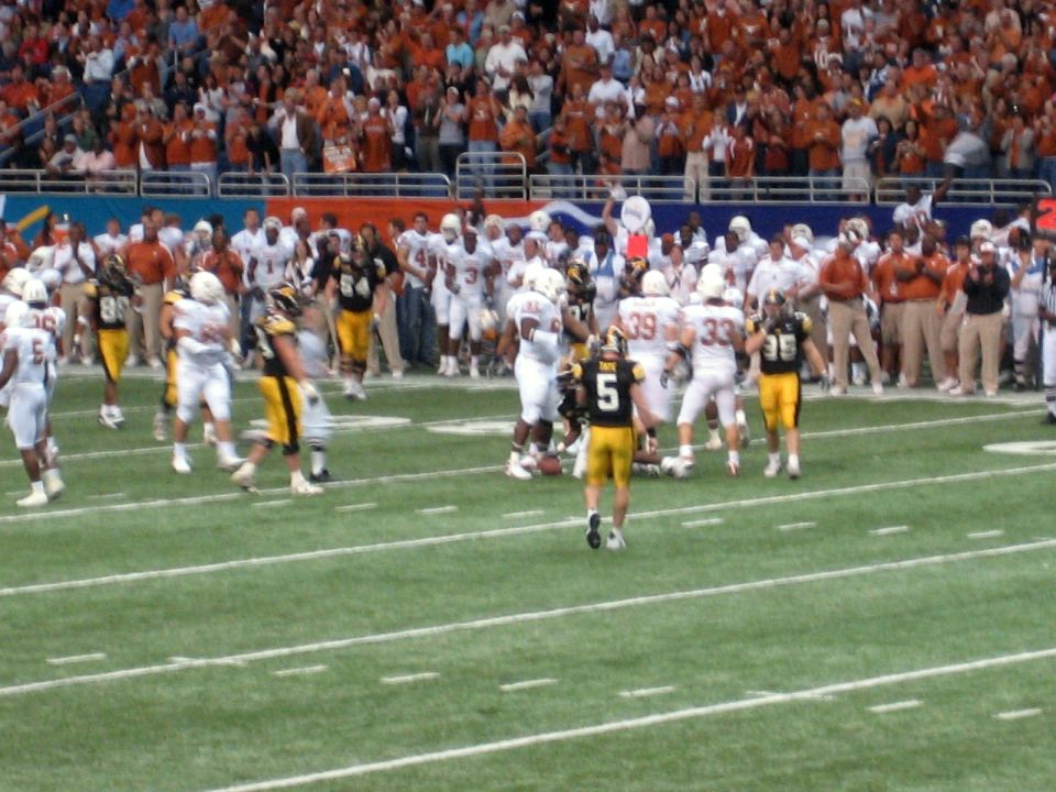 football players on field with crowd in background