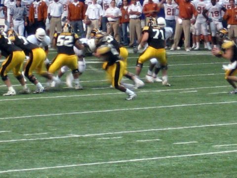 1986 Ford Bronco - Players in yellow and black uniforms are on a football field during a game.