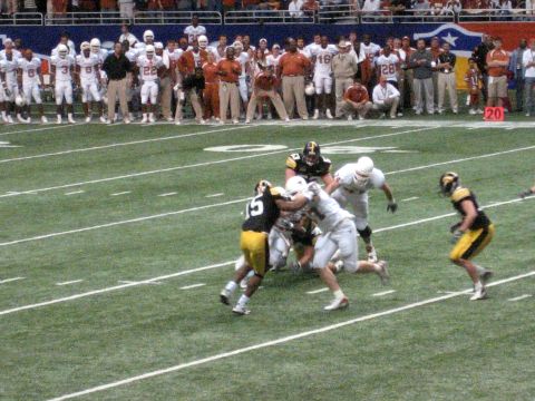 1986 Ford Bronco - A football game is underway with players in white and black and yellow uniforms on the field.