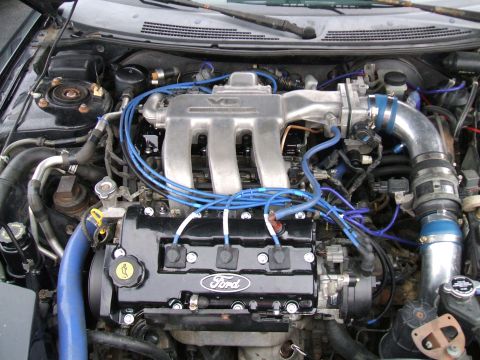 1997 Ford Probe - Close-up of a Ford V6 engine, showing the intake manifold and spark plug wires.
