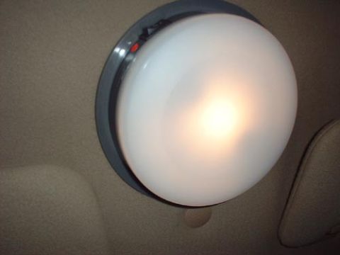 1997 Ford Crown Victoria - Close-up of a car's interior dome light, illuminated.