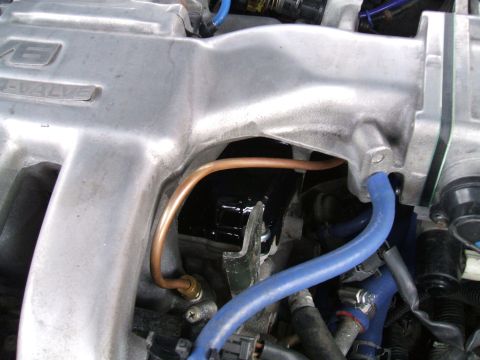 1997 Ford Probe - Close-up view of engine components, including the intake manifold and various hoses.