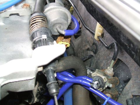 1997 Ford Probe - A detailed view of various hoses and mechanical parts within a vehicle's engine bay.