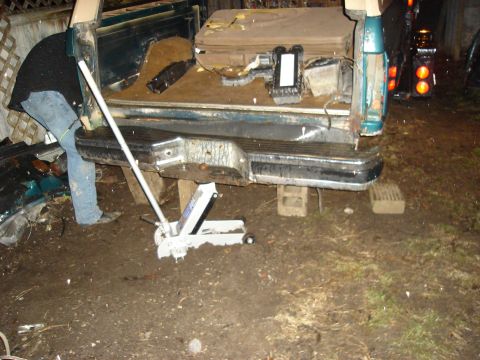 1990 Ford Bronco - Working on the rear of a 1990 Ford Bronco, supported by a jack and blocks.