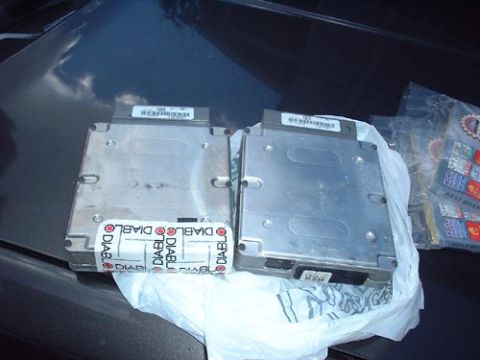 1997 Ford Crown Victoria - Two engine control units, possibly for performance tuning, are shown with branding visible on their labels.