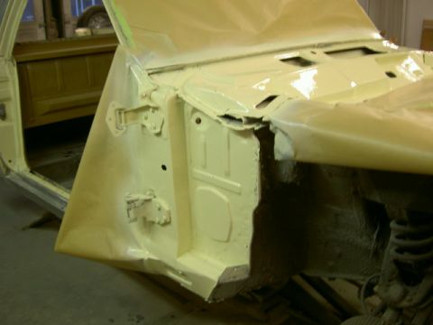 1967 Ford Ranchero - This image shows the fender well and door frame of a vehicle being prepped for paint, with masking tape visible.