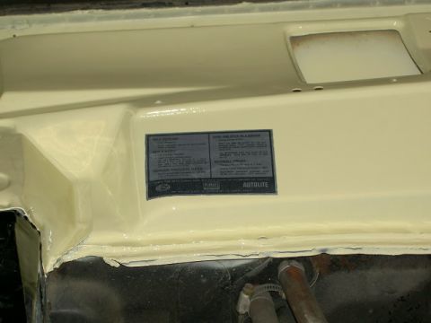 1967 Ford Ranchero - A data plate with vehicle specifications is affixed to the inner fender of a car.