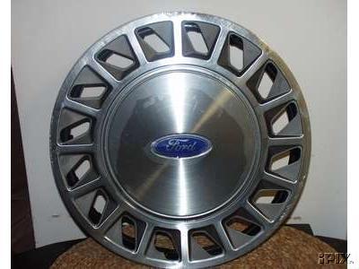 1997 Ford Crown Victoria - Ford hubcap with a silver finish and a blue Ford oval emblem in the center.