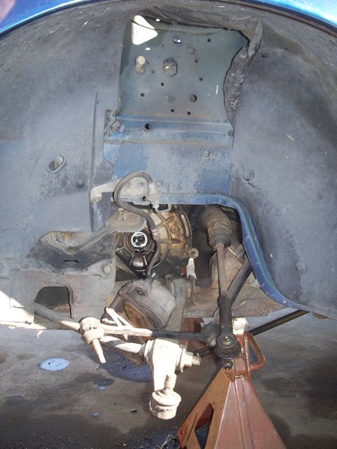 1992 Ford Taurus - This photo shows the exposed transmission and suspension components of a vehicle, likely during maintenance or repair.