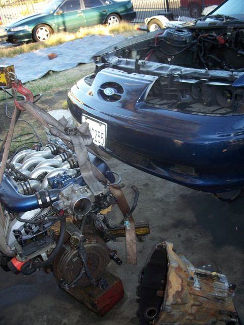 1992 Ford Taurus - Engine removal in progress, with a second vehicle visible in the background.