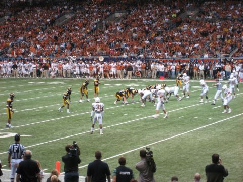 1986 Ford Bronco - Players line up on a football field during a game, with a large crowd in the stadium seating.
