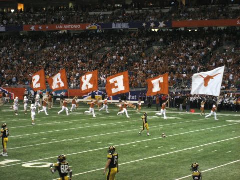 1986 Ford Bronco - Alamo Bowl football game players, fans, and team flags in San Antonio.