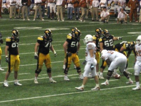 1986 Ford Bronco - Players from two football teams face off on the field during a game.