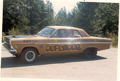1967 Ford Fairlane - Side view of a weathered brown 1966 Ford Fairlane modified for racing, displaying "the DEFENDER" and "PANDORA TEXACO" livery.