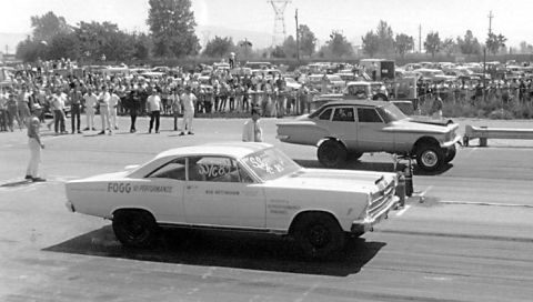 1967 Ford Fairlane - Two cars prepare for a drag race, with a crowd gathered to watch the event.